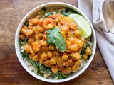 Slow Cooker Chickpea Curry served in a bowl with spinach and rice