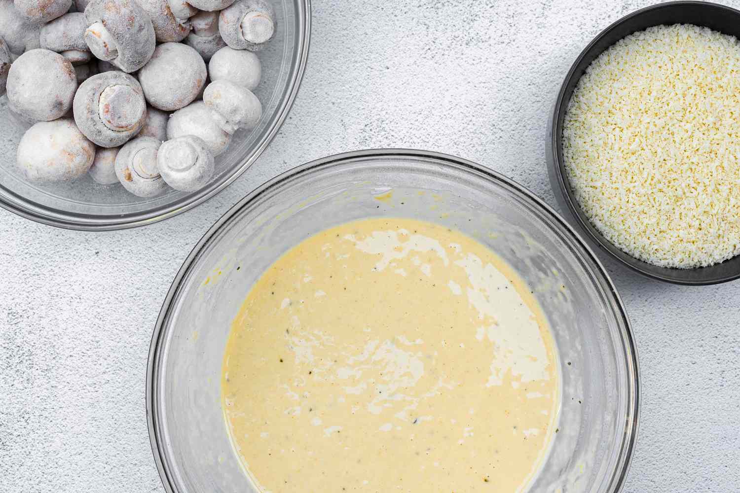 Bowl of Batter, Bowl of Panko, and Bowl with Coated Mushrooms