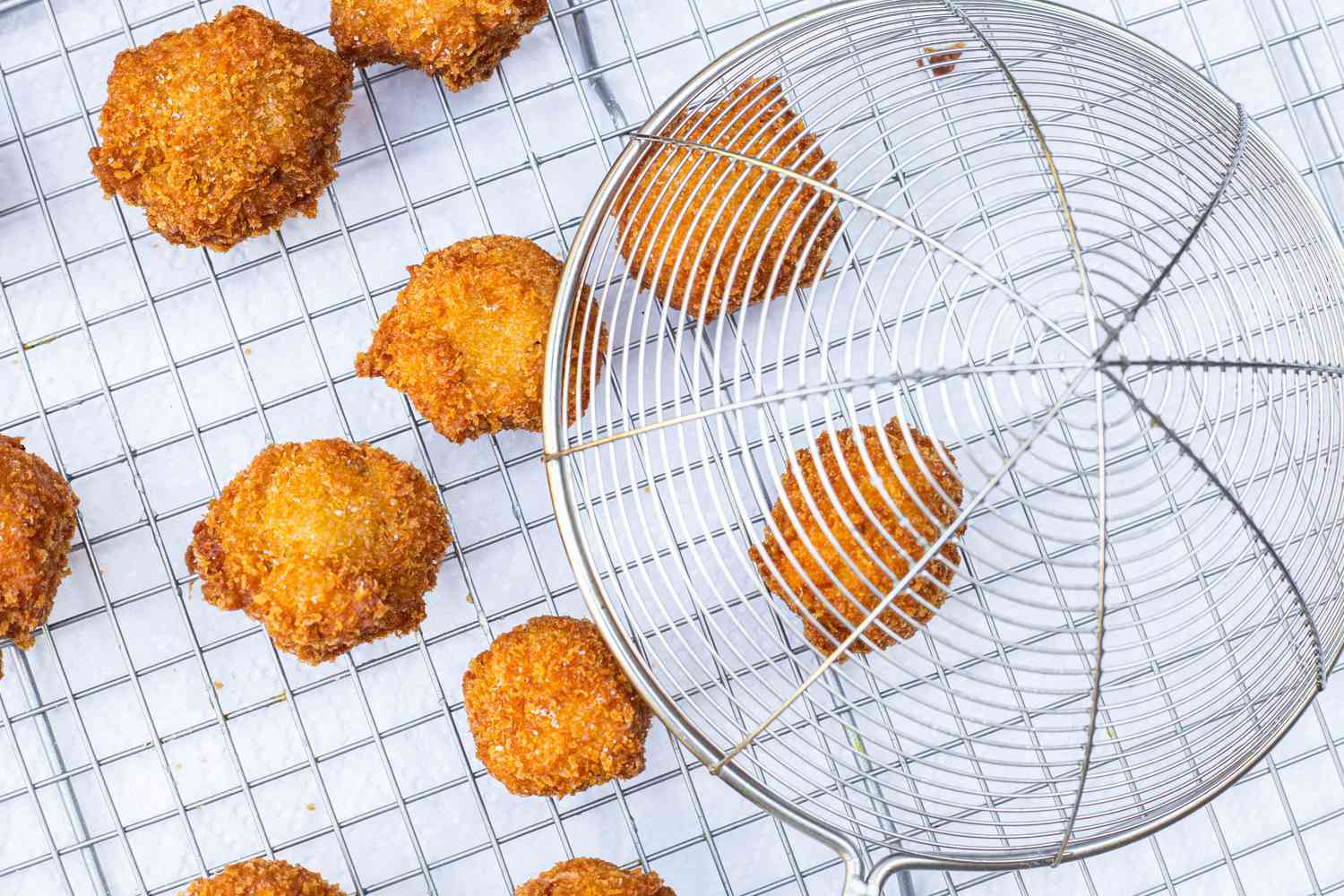 Cooked Fried Mushrooms Placed on Cooling Rack with Paper Towels Underneath