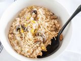 Risotto with Mushrooms - white bowls filed creamy mushroom risotto