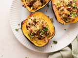 Overhead view of three vegetarian stuffed squash on a platter.