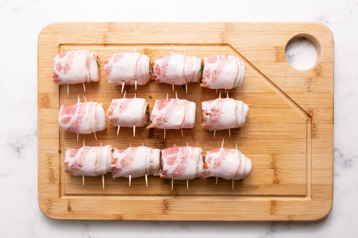 Bacon-Wrapped Salmon on Cutting Board for Grilled Bacon-Wrapped Salmon Bites with Lemon Garlic Mayo