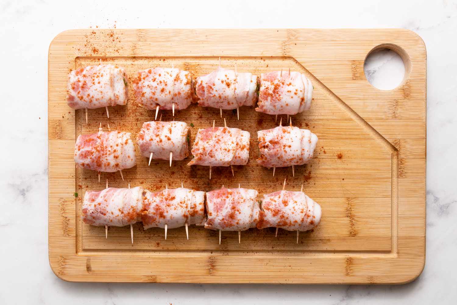 Season Bacon-Wrapped Salmon on Cutting Board for Grilled Bacon-Wrapped Salmon Bites with Lemon Garlic Mayo