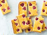 Raspberry chess pie bars cut and stacked.