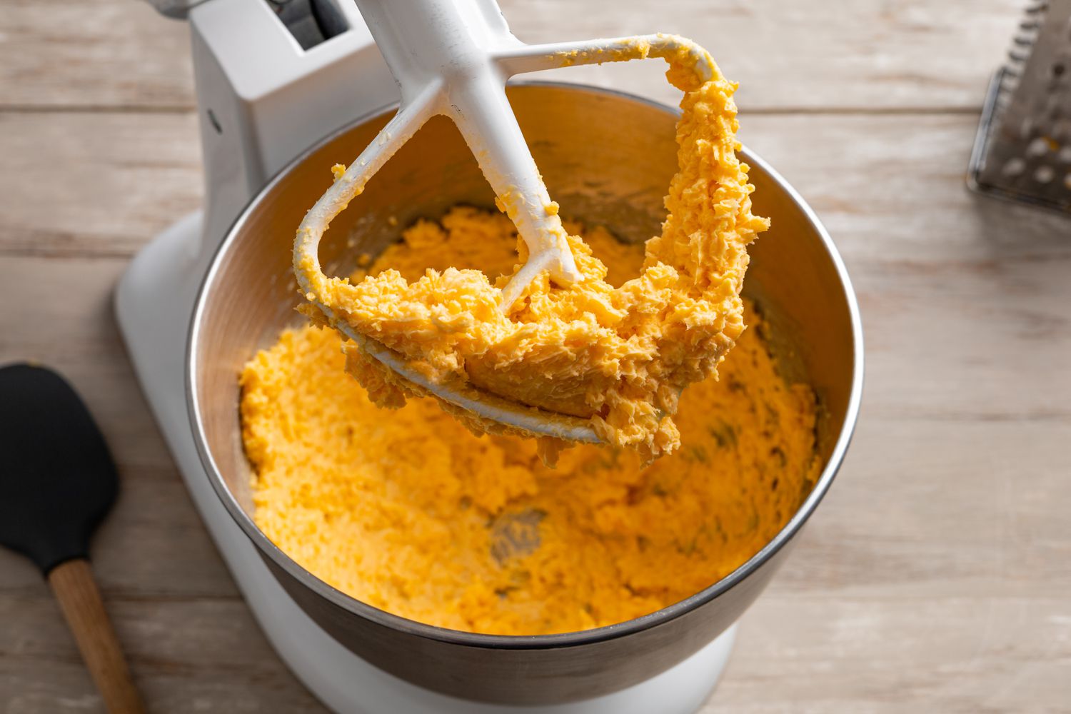 Cheese Straws Dough on a Mixer Flat Beater Attachment with the Rest in the Mixer Bowl