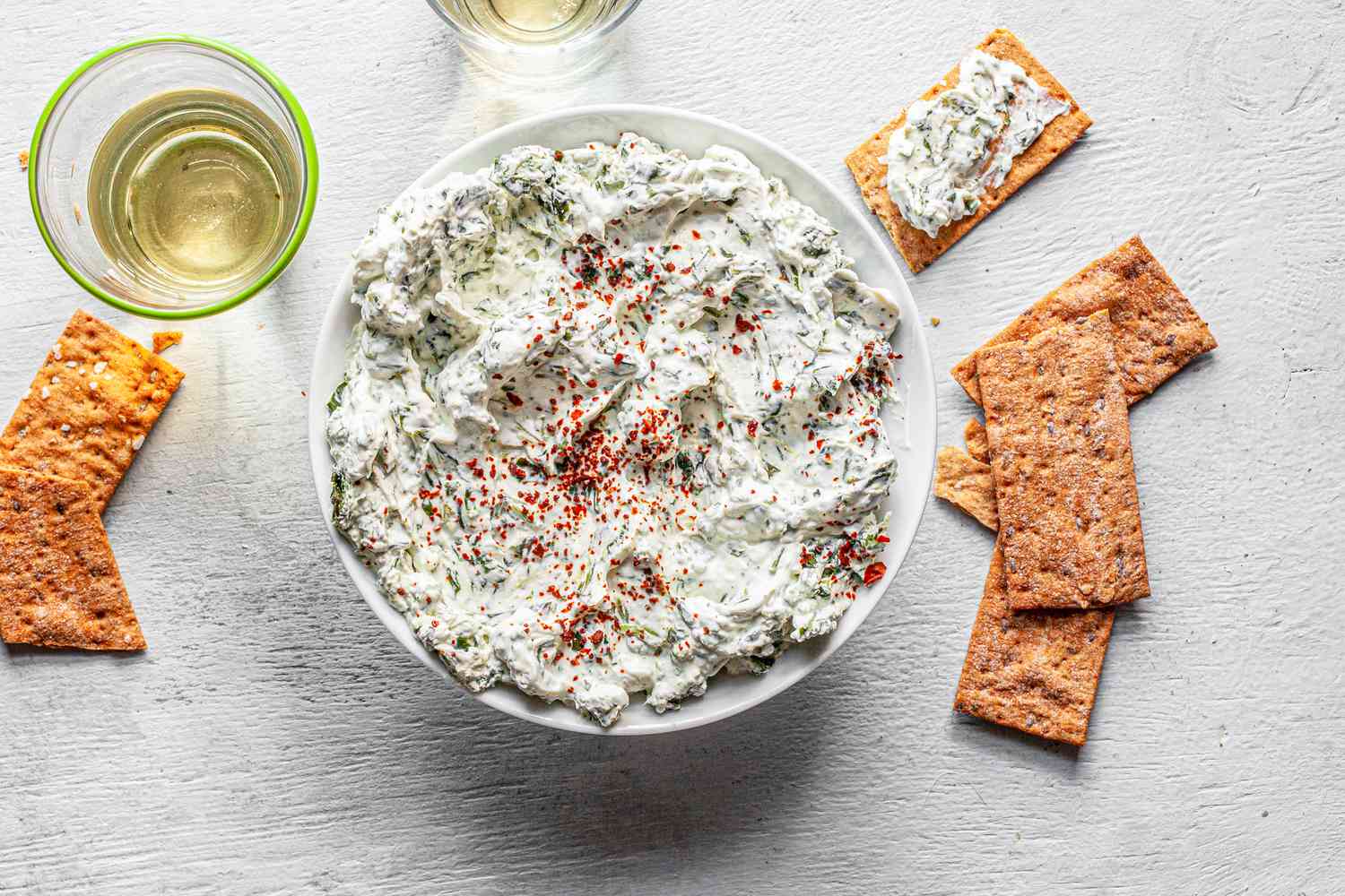 Bowl of Easy Spinach Dip Surrounded by Crackers