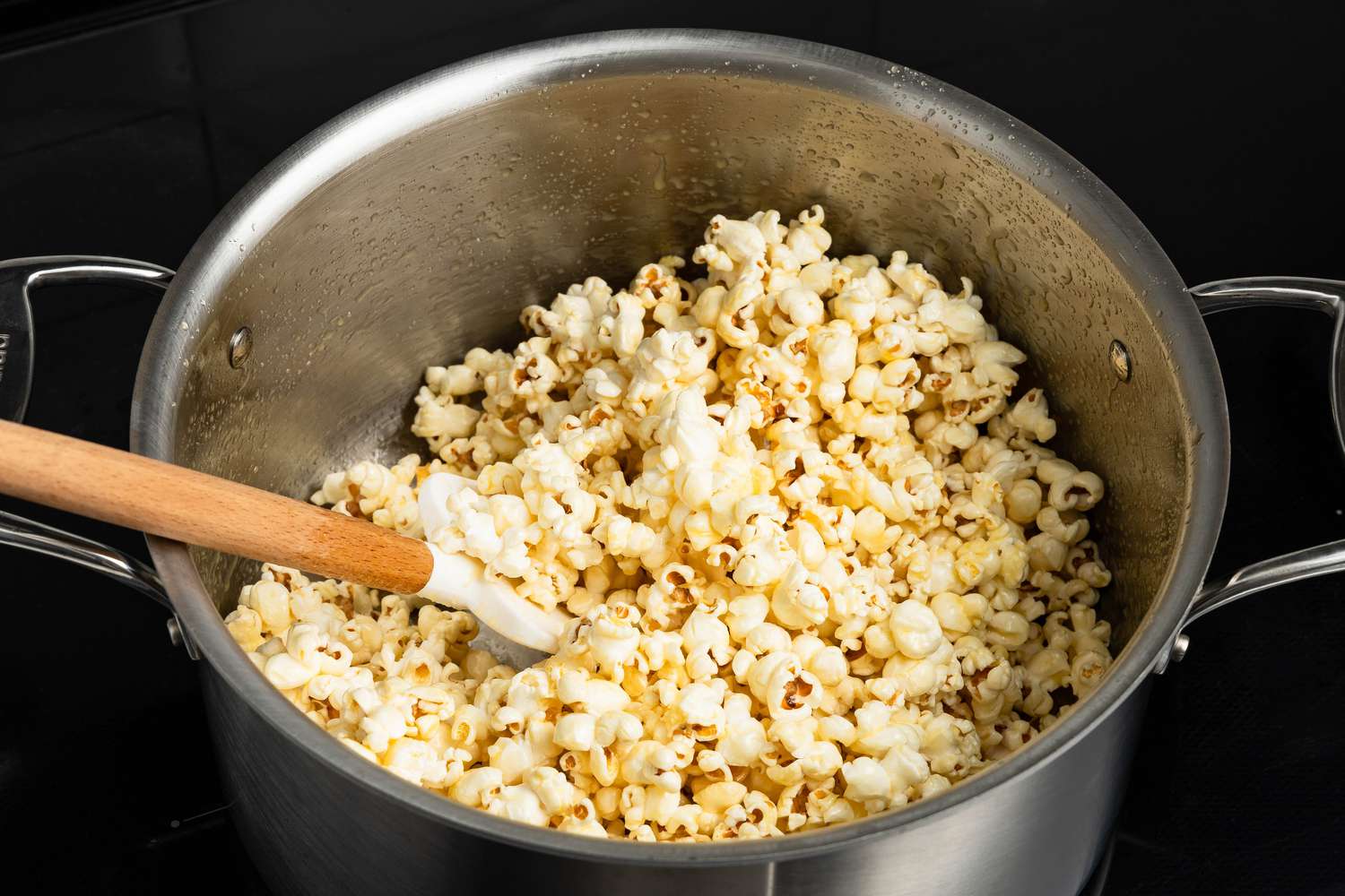 Pot of honey popcorn with a spatula