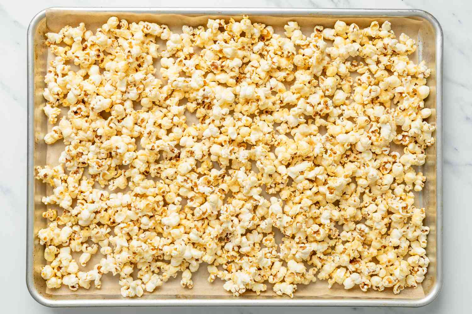 Baked honey popcorn on the parchment paper lined baking tray 