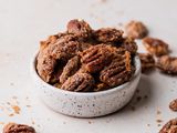 Side view of a bowl of candied pecans.