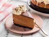 No-bake chocolate cheesecake slice on a pink plate with a fork