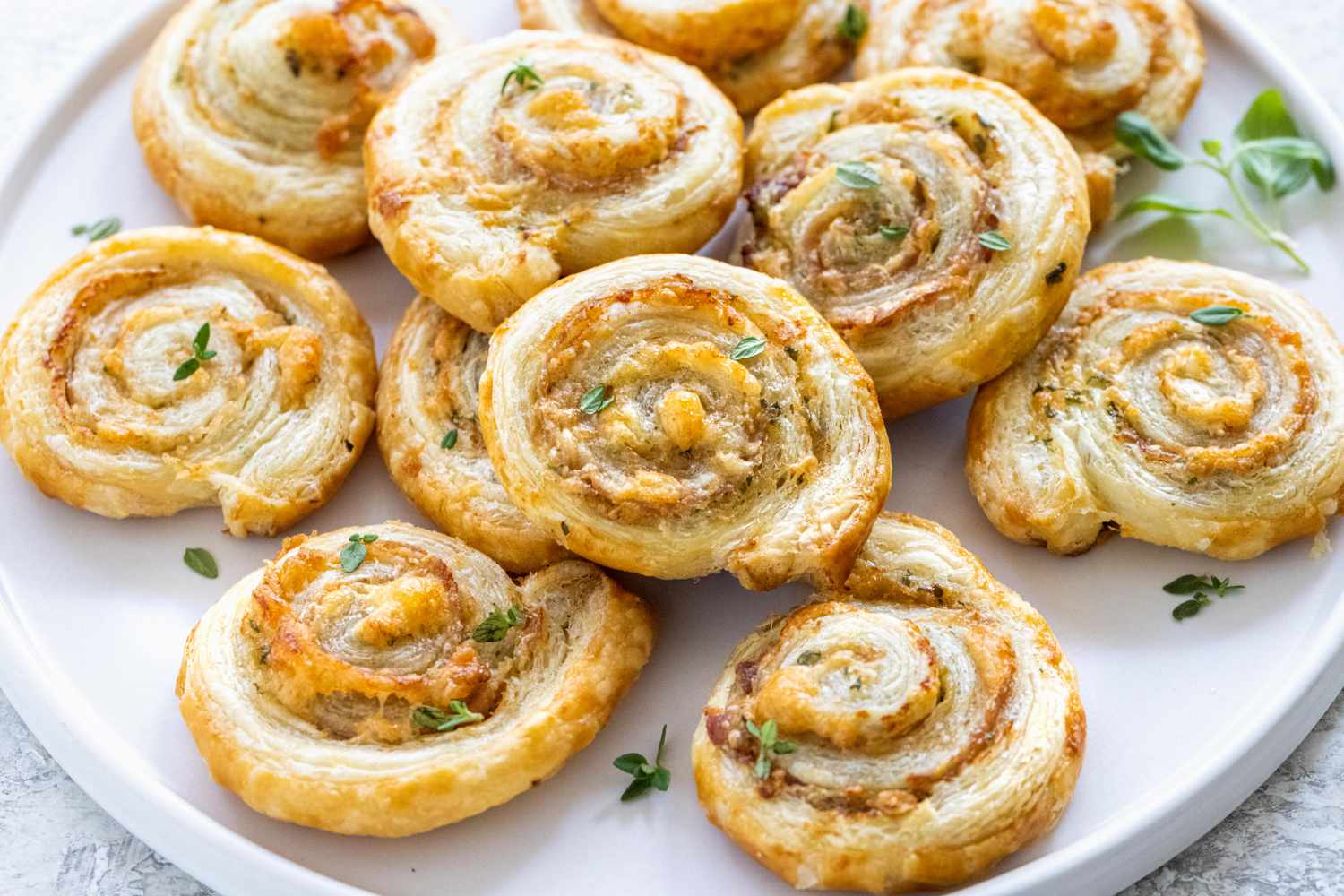 Savory pinwheels on a white platter.