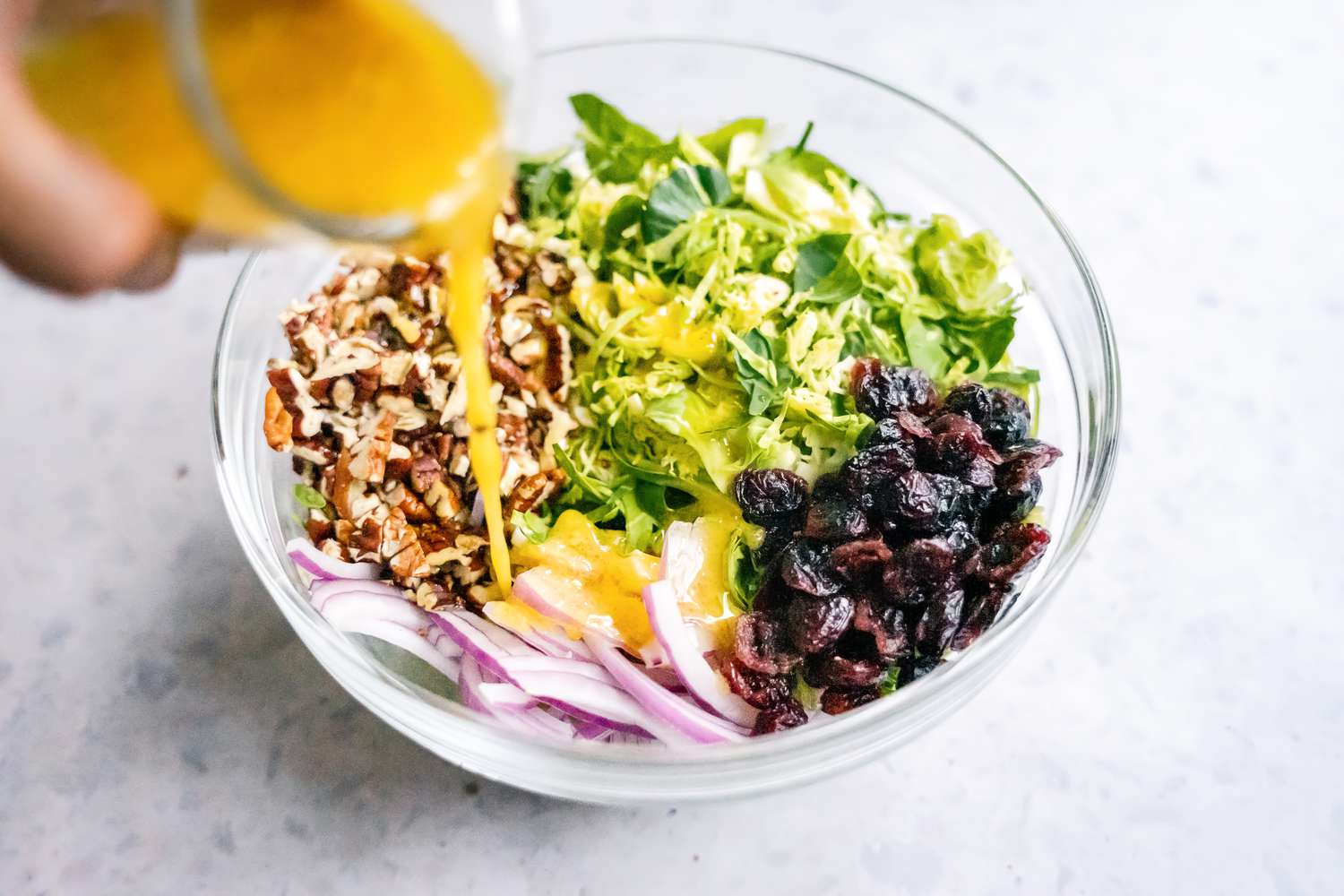 Dressing Added to Bowl of Brussels Sprouts Slaw Ingredients