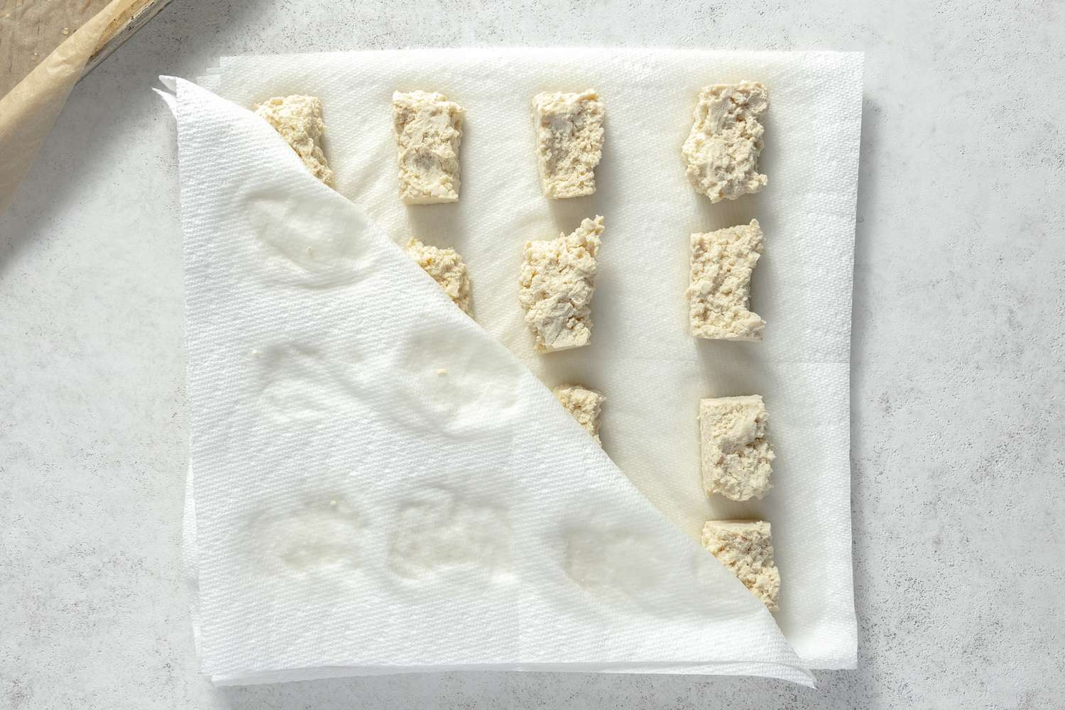 Tofu Nuggets in Between Layers of Paper Towels on the Counter for Chicken Nuggets Vegan Recipe