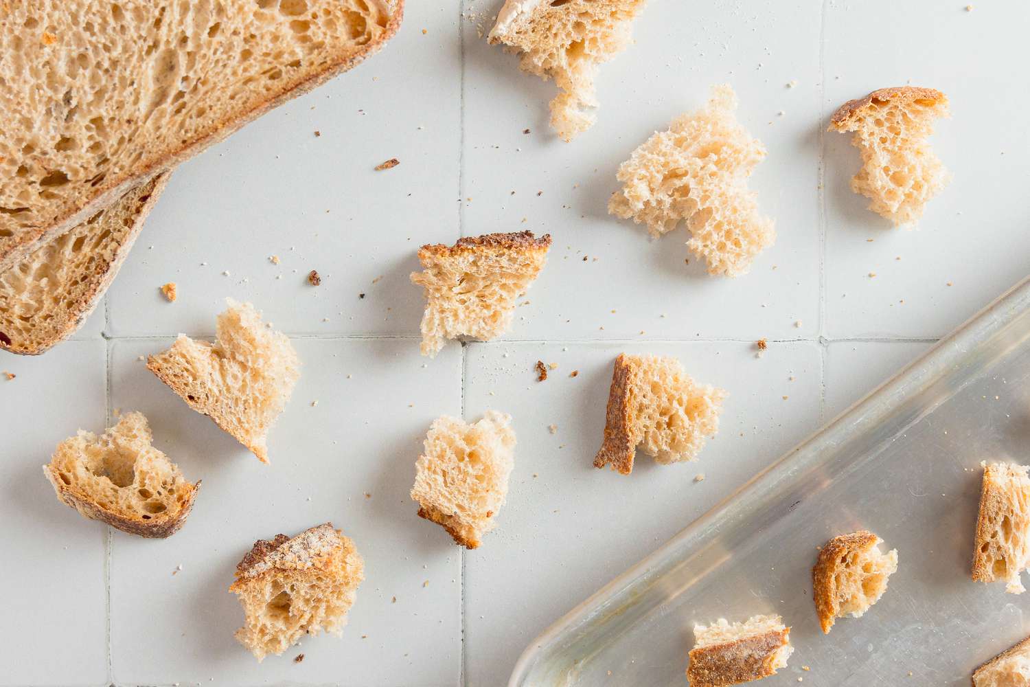 Bread Torn into Bite Size Pieces and Placed on a Baking Pan for Roasted Root Vegetable Panzanella Recipe