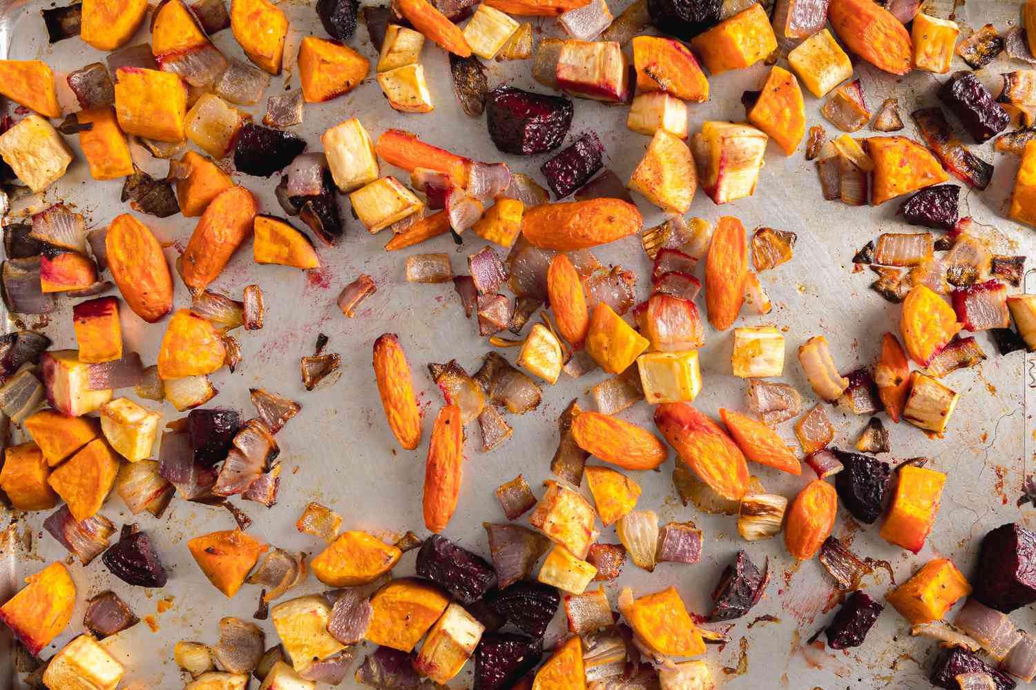 Roasted Red Onion, Carrots, Parsnips, Sweet Potatoes, and Beets on a Baking Tray